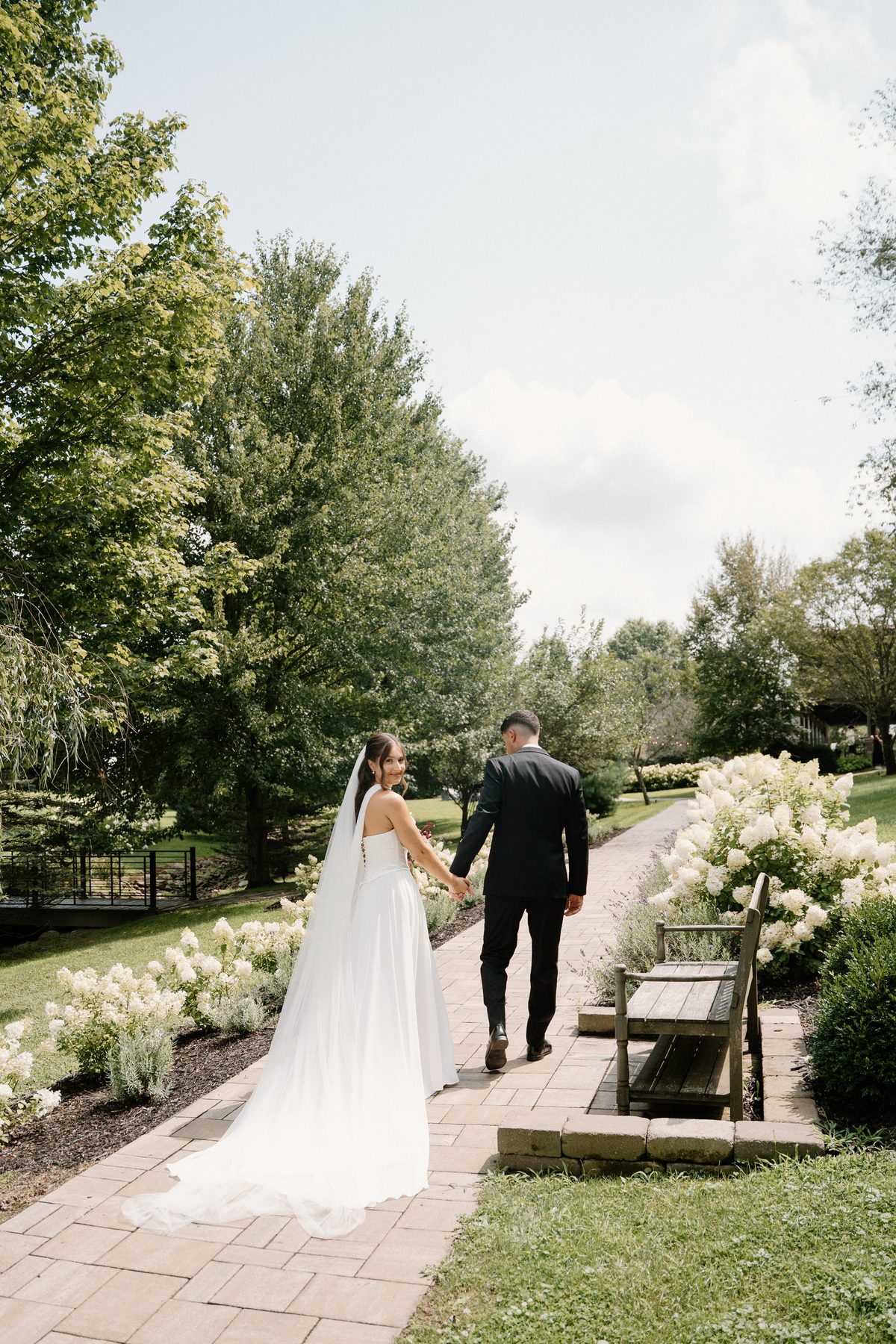 Bride and groom walking away showing the gown train — Pittsburgh wedding
