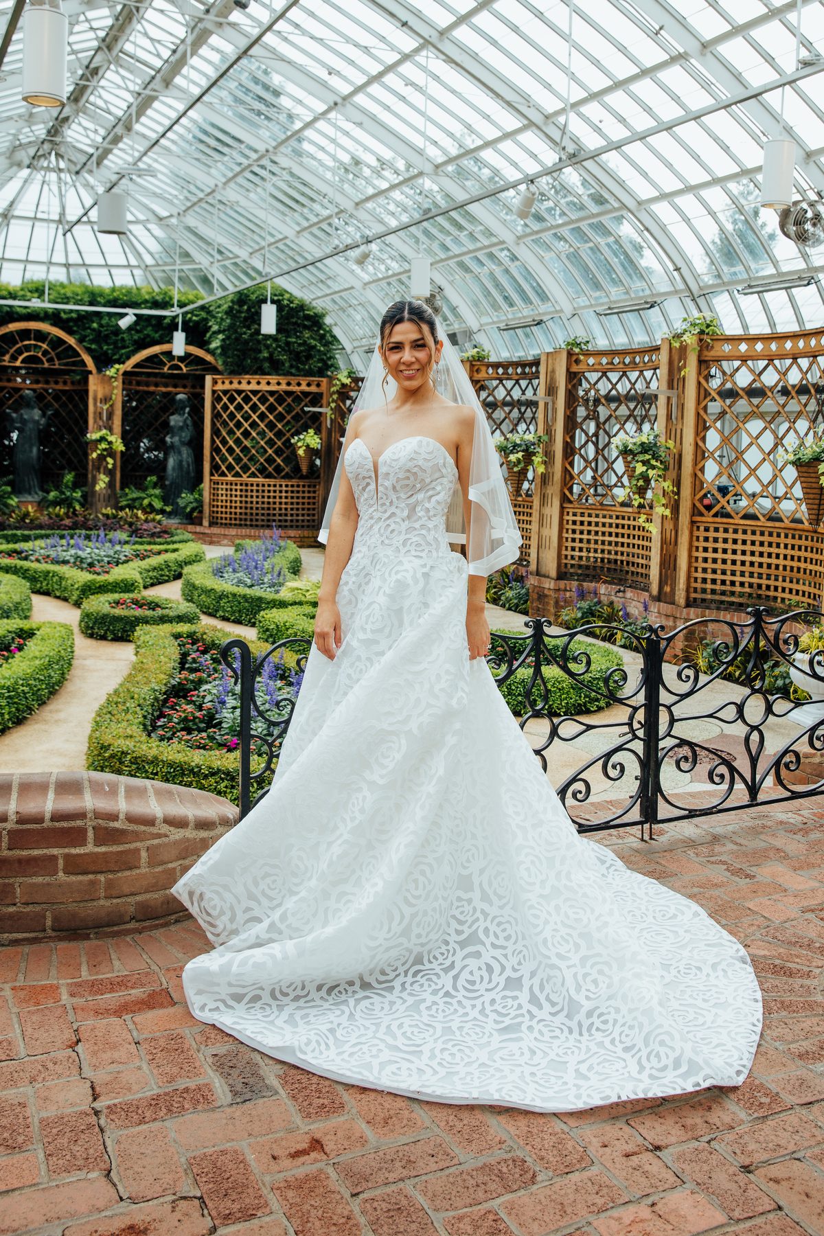 Bride in a glass conservatory wearing a beaded gown — GISS Beauty bridal makeup