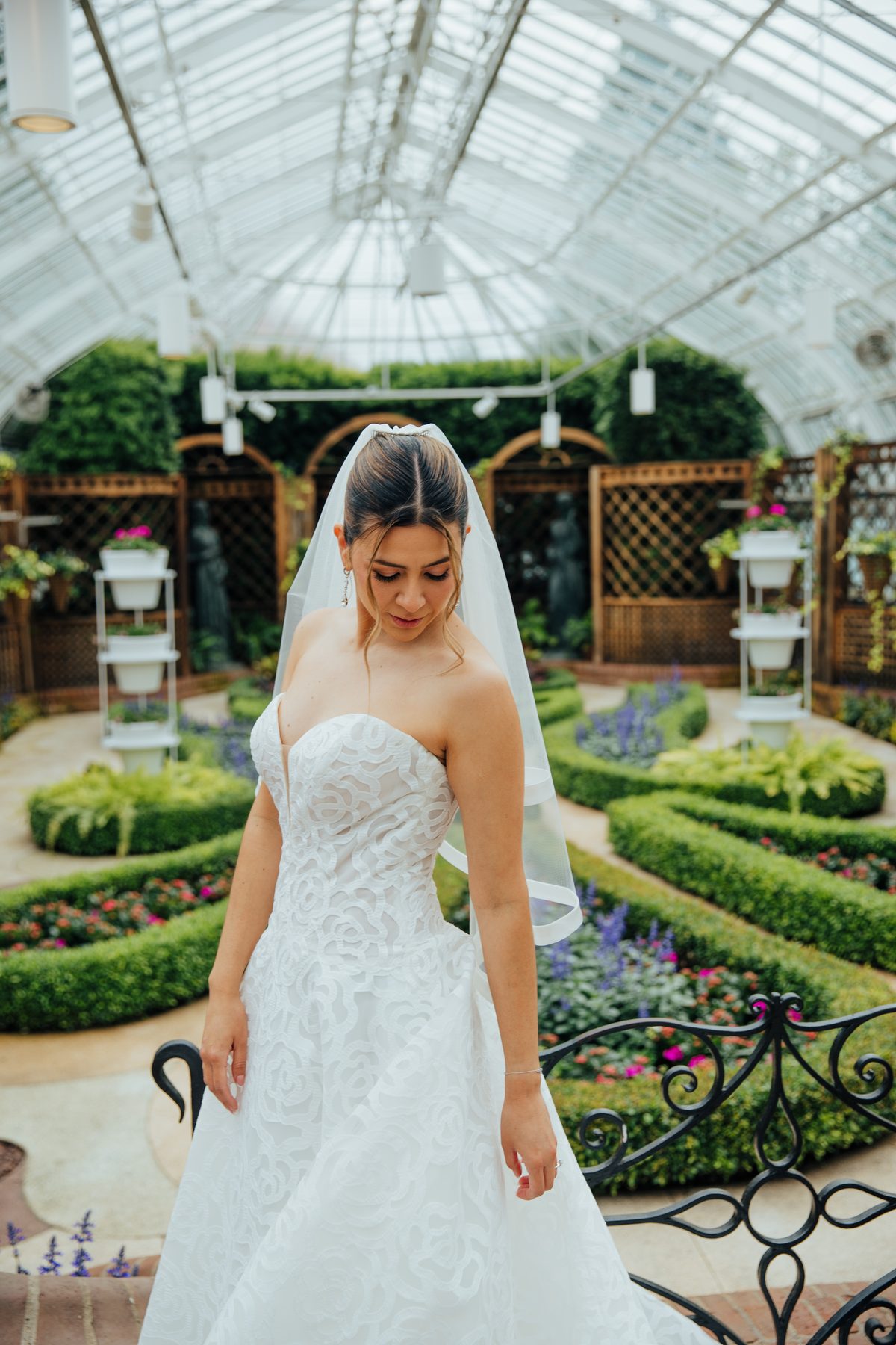 Bride with cathedral veil in a conservatory — bridal makeup by Gissell