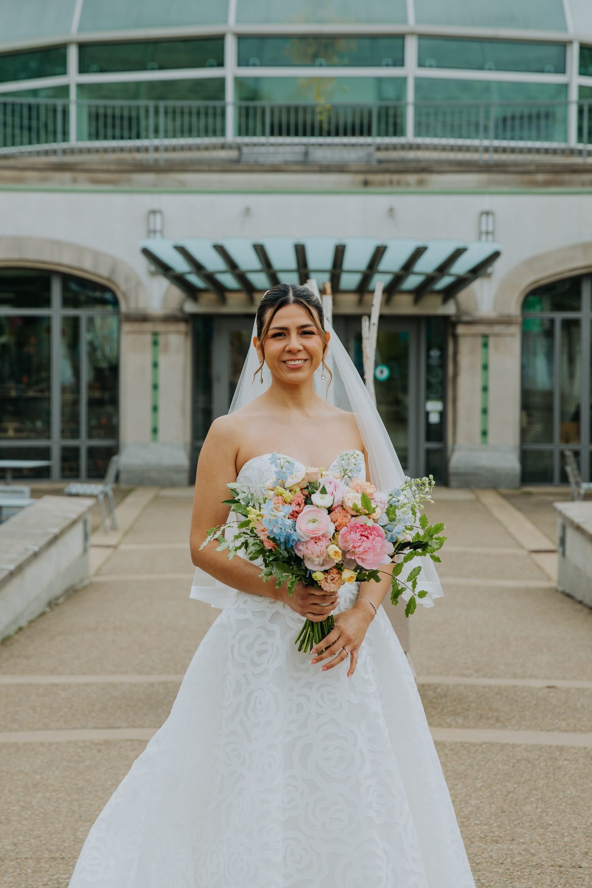 Bride with a spring bouquet at her wedding venue — GISS Beauty bridal makeup